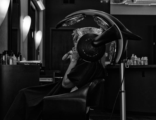 man in black suit sitting on black leather armchair