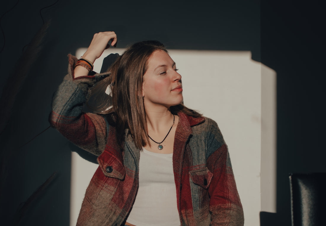 a woman standing in front of a white wall