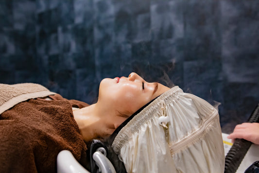 a woman getting her hair brushed by a blow dryer